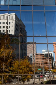 American Reflections shows a 35mm digital colour photo of reflections of office buildings in large glazed windows in bright sunshine. 