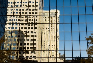 American Reflections shows a 35mm digital colour photo of reflections of office buildings in large glazed windows in bright sunshine.