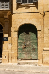 This Vanishing Malta project photograph captures a digital colour image of the door to an abandoned old building in Valetta.