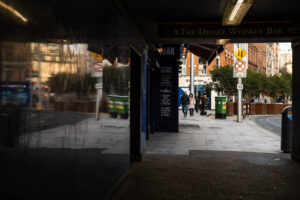 A Friday stroll in Dublin City showing 35mm digital image of a reflection of a street taken under the entrance to scaffolding on a mid-morning walkabout around parts of the city centre