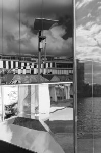 Liffey Quay Dublin Reflections shows a 35 mm digital image of a structure on the quay that had highly reflective angled surfaces allowing the surrounding infrastructure to be seen in an abstract fashion