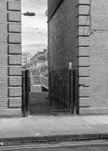 A black and white digital photographic image of old and new buildings taken during a stroll through the docklands' area of Dublin City..