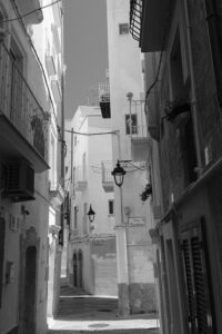 Monopoli Italy Scenes shows a 35mm digital image in monochrome of a quiet street in the old town part of Monopoli, Puglia, Italy 