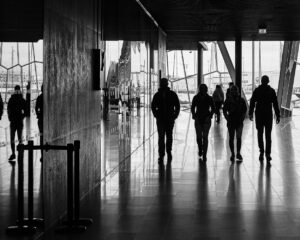 Silhouette shows a 35mm digital image of the backs of four people exiting a conference hall.