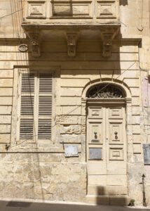 Vanishing Malta shows a 24mm digital colour image of an old and now empty and dilapidated sandstone building awaiting its fate.