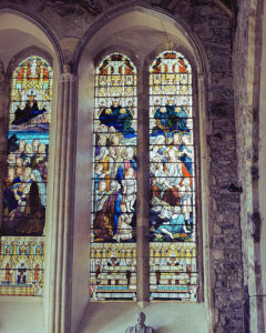 Youghal Film Images shows a 35mm Kodak Ektar colour film photo of stained glass panels in the medieval church in the town.