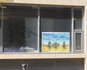 Some recent Additions shows a 35mm digital image of a photo or poster in the ground floor window of an empty office block in Dublin City