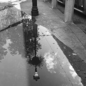 New Photos shows a 35mm black and white digital image of a refection in a pool on a street after rain in Dublin City, Ireland